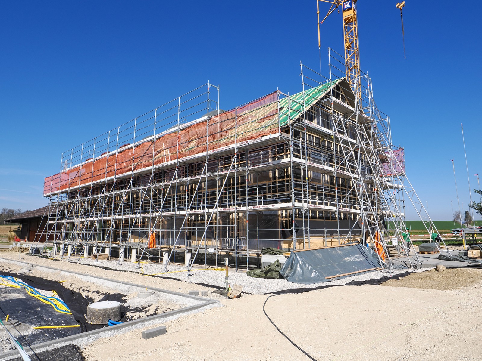 23.04.2025 Die Holzelementbauten der Reihenhäuser 31a-d sind fertig montiert. Nun sind wir daran, deren Gebäudehüllen zu erstellen. Das Tiefgarageneinfahrtsgebäude befindet sich in der Fertigstellung. Parallel dazu sind die Umgebungsarbeiten in vollem Gang und bereits die ersten Bäume gepflanzt. Das Haus 31d ist neu reserviert und das Haus 29b wird ab Mai zum fertig ausgebauten Musterhaus ausgebaut.
